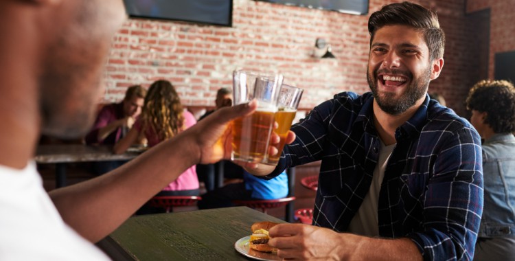 man smiling at a sports bar