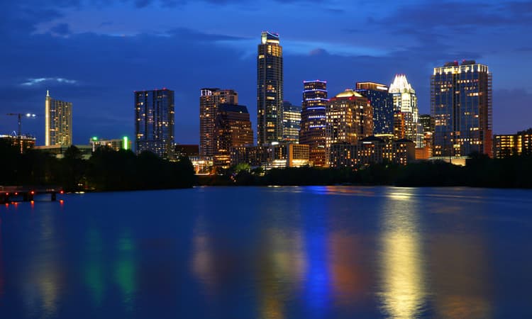 night time austin cityline reflected on river