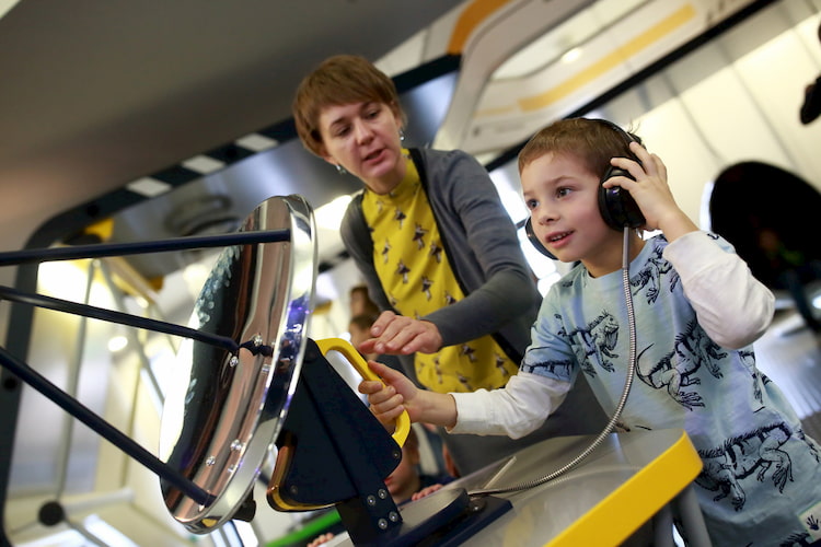 Child tuning the radar in lab at museum