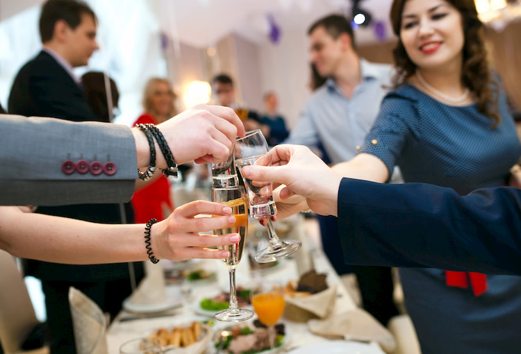 People enjoy champagne and appetizers at a special event.