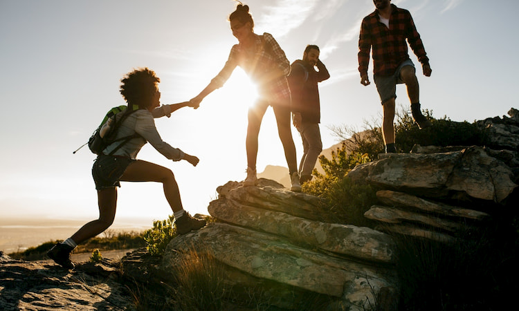 hikers climb to the summit of Enchanted Rock in Texas