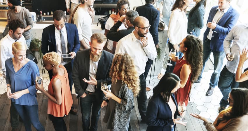 group of businesspeople networking with food and drinks