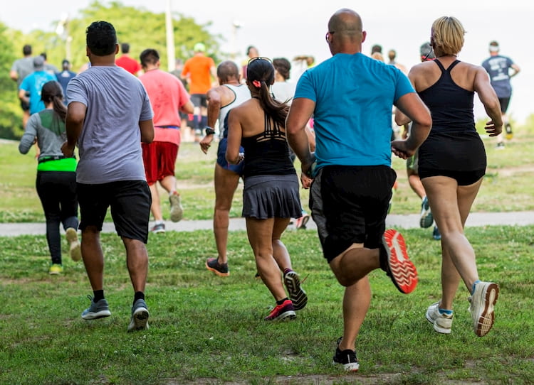 runners head across a patch of grass at the all out trinity race