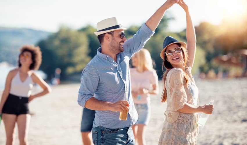 A group of people smiling and laughing on the beach