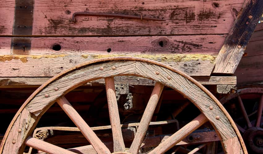 close-up image of a stagecoach's wagon wheel