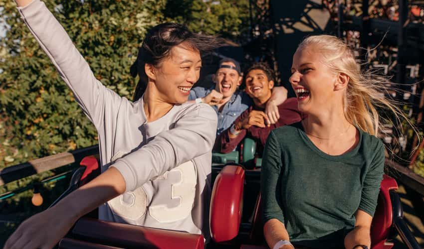 People smiling on a rollercoaster