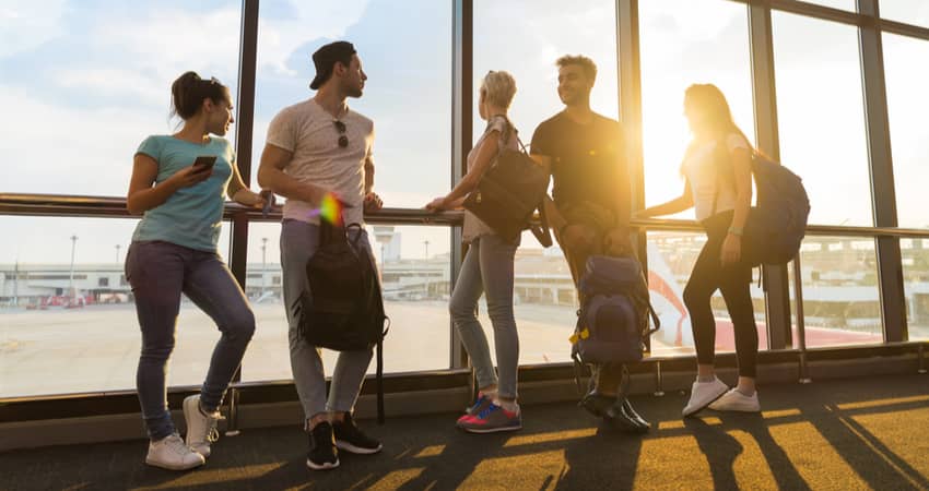 A group of people waiting at a Dallas airport gate