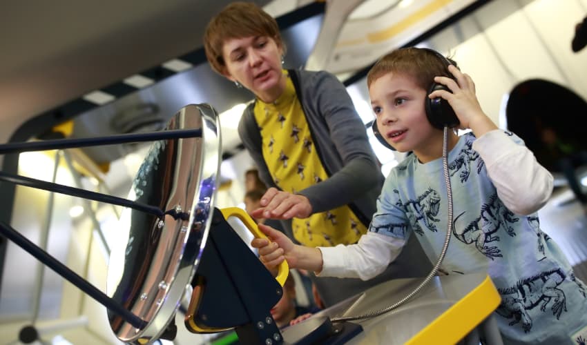 A child plays with a radar replica at a space museum