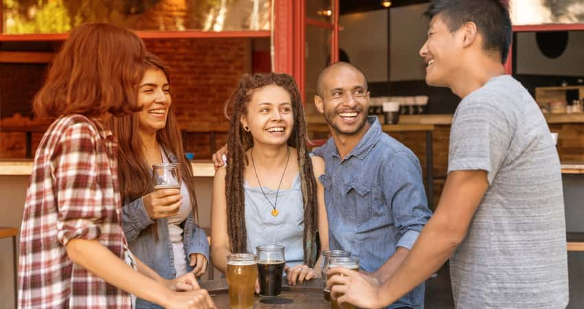 A group of people having beer outside at a brewery