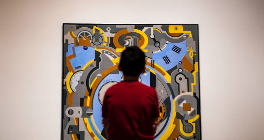 A child stands in front of a bright graphic art piece in the Dallas Museum of Art