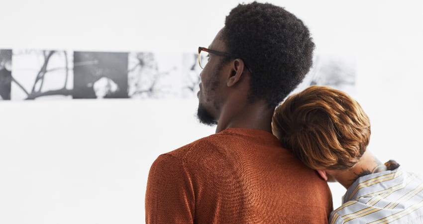 A couple admire a black and white photography exhibition in a gallery