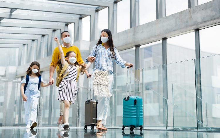 a family rolls their suitcases through the san antonio airport