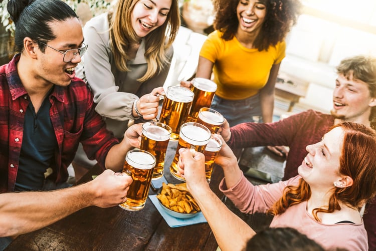 friends cheers their beers at a brewery