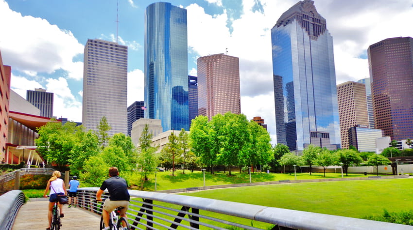 People cycling on a trail along Buffalo Bayou in Houston