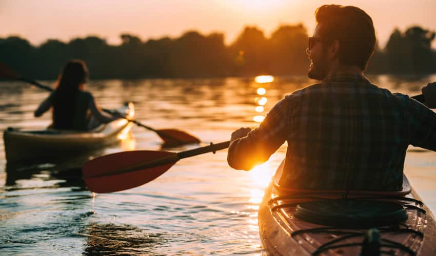 People kayaking at sunset