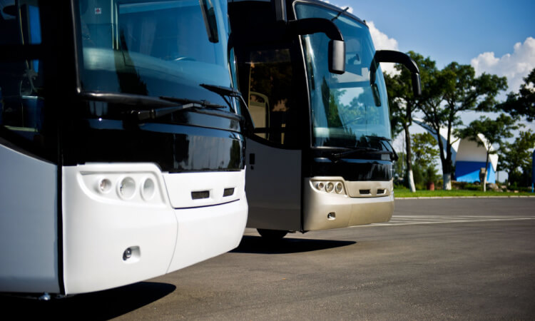 a close up of two charter buses