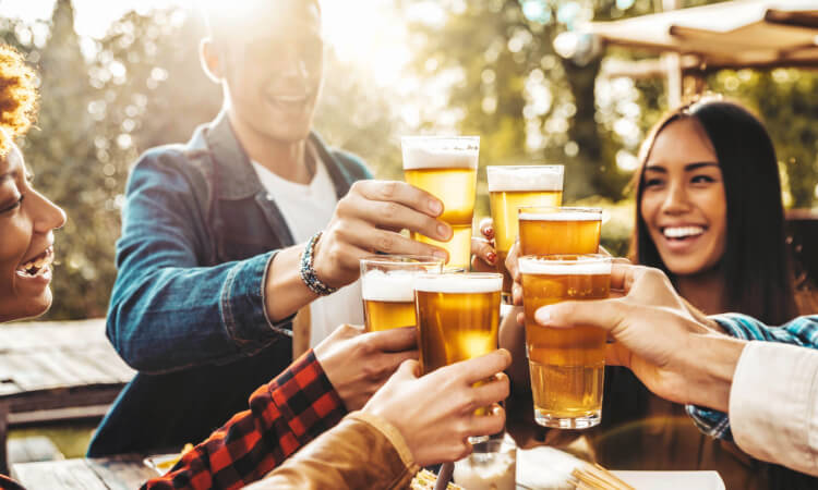 a group of people toasting beer