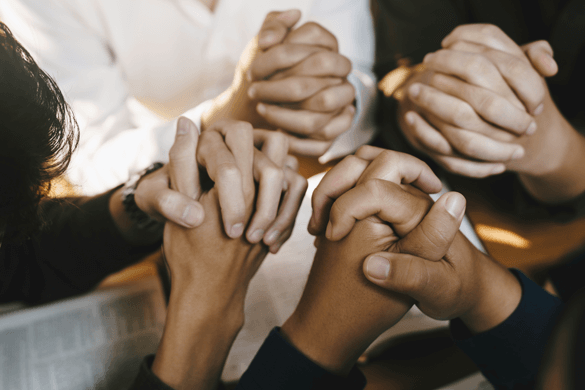 a group of hands praying